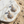 Load image into Gallery viewer, Gold sunburst earrings with clear stones on a marble surface with sand and pebbles.
