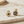 Load image into Gallery viewer, Two gold earrings with gemstones on a marble surface
