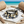 Load image into Gallery viewer, Bracelet with pearls and crystals on a marble slab with beach background
