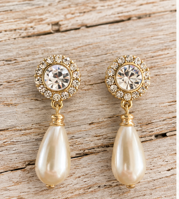 Rhinestone and faux pearl drop earrings on pale barn wood