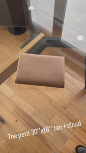a video showing the tan and gray desk mat 