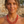 Load image into Gallery viewer, Woman wearing a red beaded necklace with a blurred natural background

