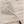Load image into Gallery viewer, Silver crystal hand chain bracelet with black adjustable ring on pale rustic wood
