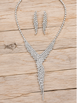 Silver rhinestone cascading necklace and earrings on pale rustic wood