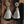 Load image into Gallery viewer, Pair of tassel earrings with gold tops on a wooden background
