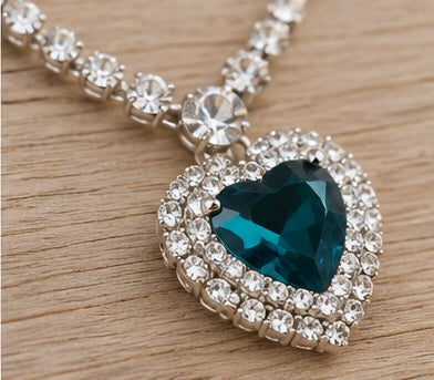 Teal heart pendant angled close-up