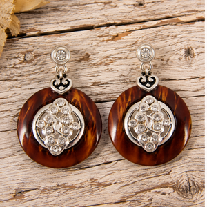 Brown tortoiseshell-style rhinestone drop earrings on pale weathered barn wood