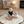 Load image into Gallery viewer, Baby and small dog sitting on a round quilt in a cozy living room.
