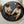 Load image into Gallery viewer, Two children playing on a round black mat with toys in a nursery setting.
