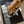 Load image into Gallery viewer, Dog eating from a bowl on a black mat with 'uniflow' branding.
