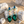Load image into Gallery viewer, Green gemstone earrings with pearl accents on a stone surface
