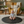 Load image into Gallery viewer, Baby sitting on a black mat in a cozy living room with a yellow armchair and decorative pillows.
