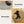 Load image into Gallery viewer, Two images of a dog lying on a reversible tan and gray mat.
