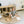 Load image into Gallery viewer, Child playing with wooden toys on a round beige mat in a playroom.
