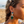 Load image into Gallery viewer, Woman on a beach wearing turquoise earrings with a blurred background
