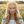 Load image into Gallery viewer, Woman with a decorative headband in a field of flowers during sunset
