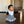 Load image into Gallery viewer, A baby wearing a black and gray bandana bib with a pattern, sitting on a floor.
